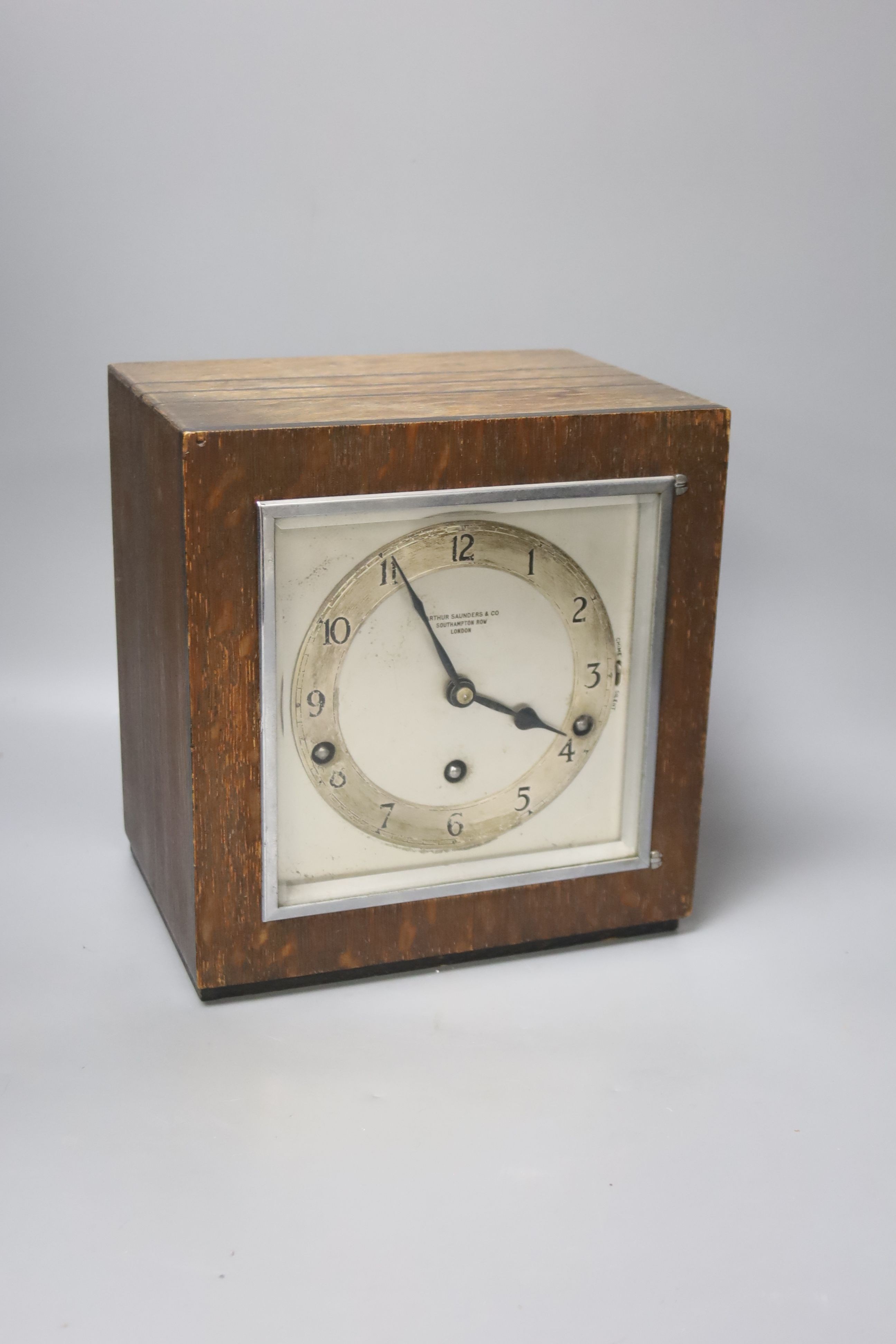 An Art Deco oak cased clock, with ebony banded borders, Arthur Saunders & Co, Southampton Row, London, 23cm high., 21 x 15cm.